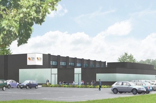 Bâtiment moderne du CLPS avec façade sombre, larges baies vitrées et parking au premier plan.